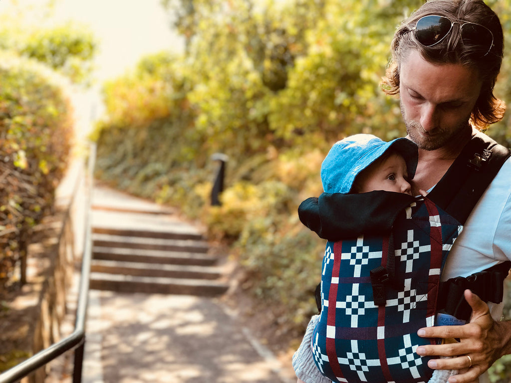Man carrying child with Integra Baby Carrier in a front carry