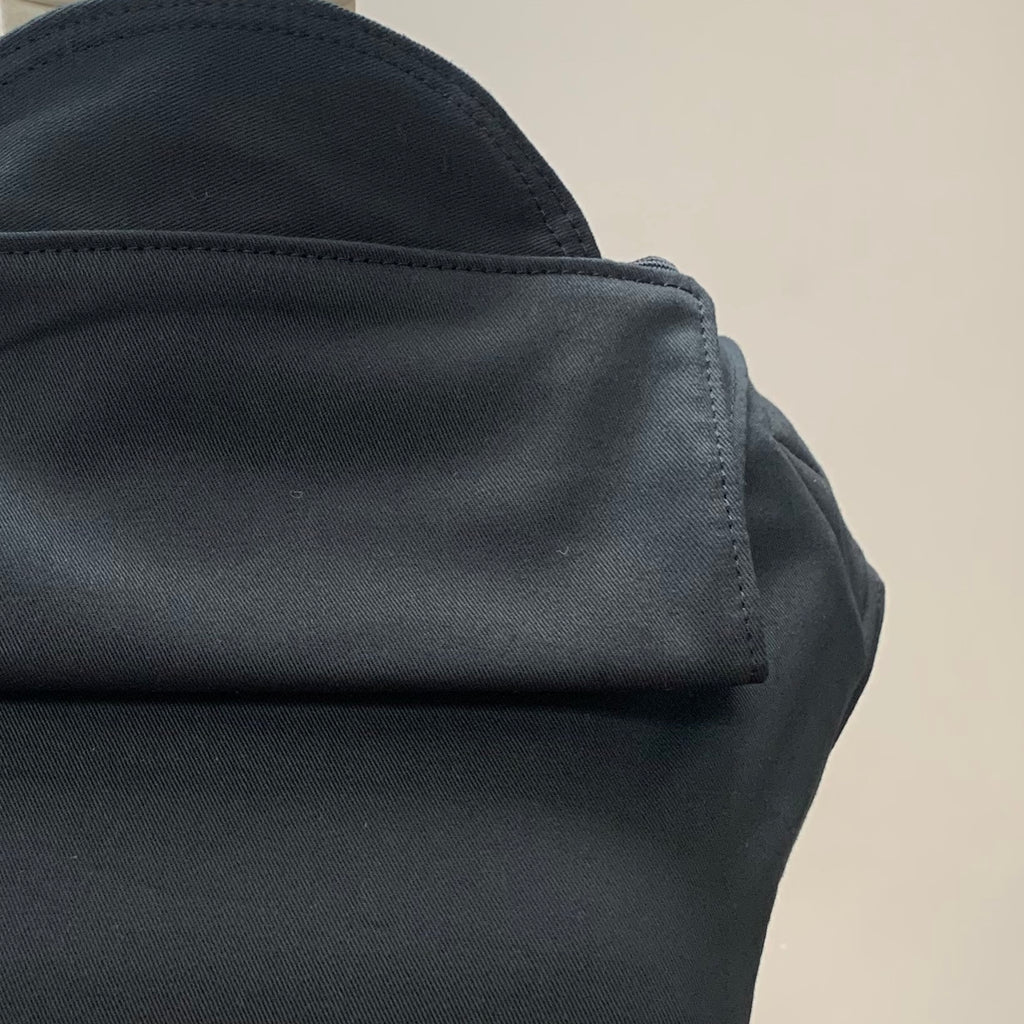 Close-up of a black Integra Baby Carrier made of Oeko Tex black cotton, showcasing the fabric texture and seaming details.