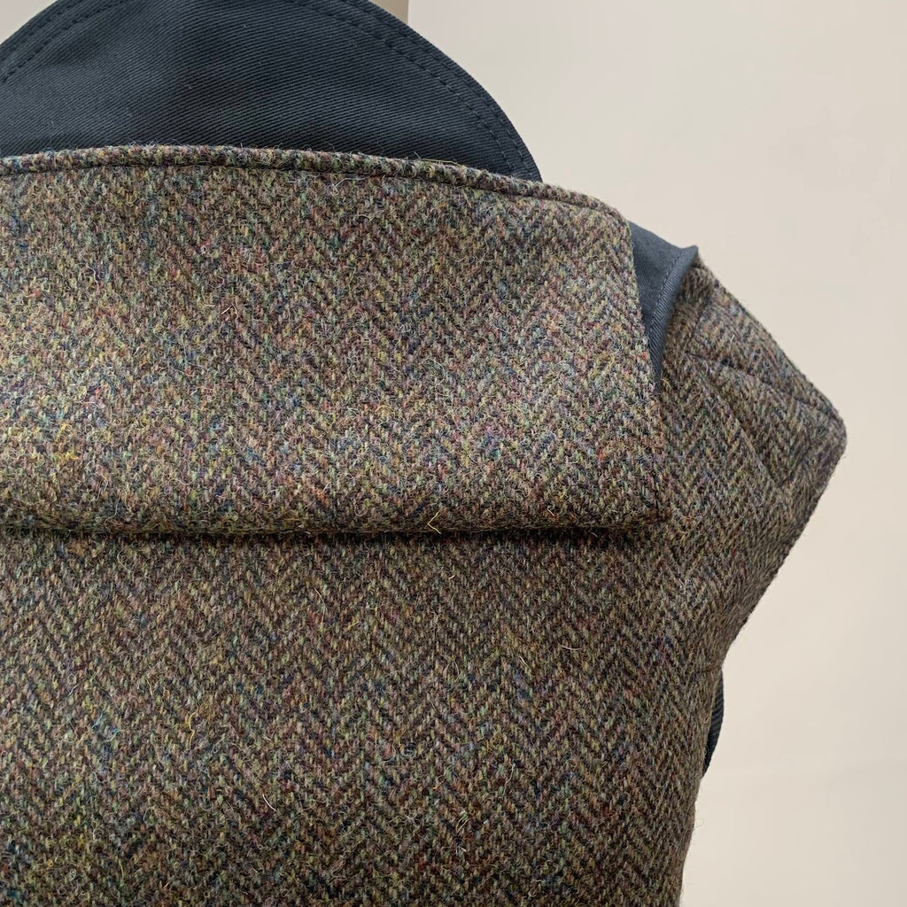 Close-up of the shoulder strap area of a brown Harris Tweed Integra Baby Carrier